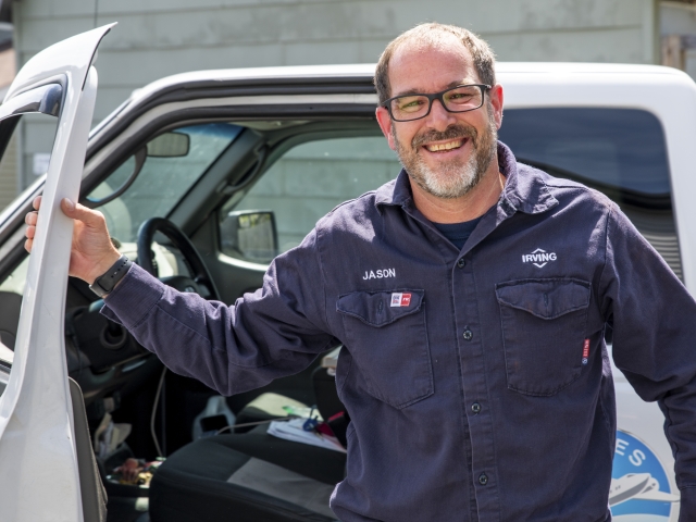 Irving Energy technician getting out of the car for equipment service